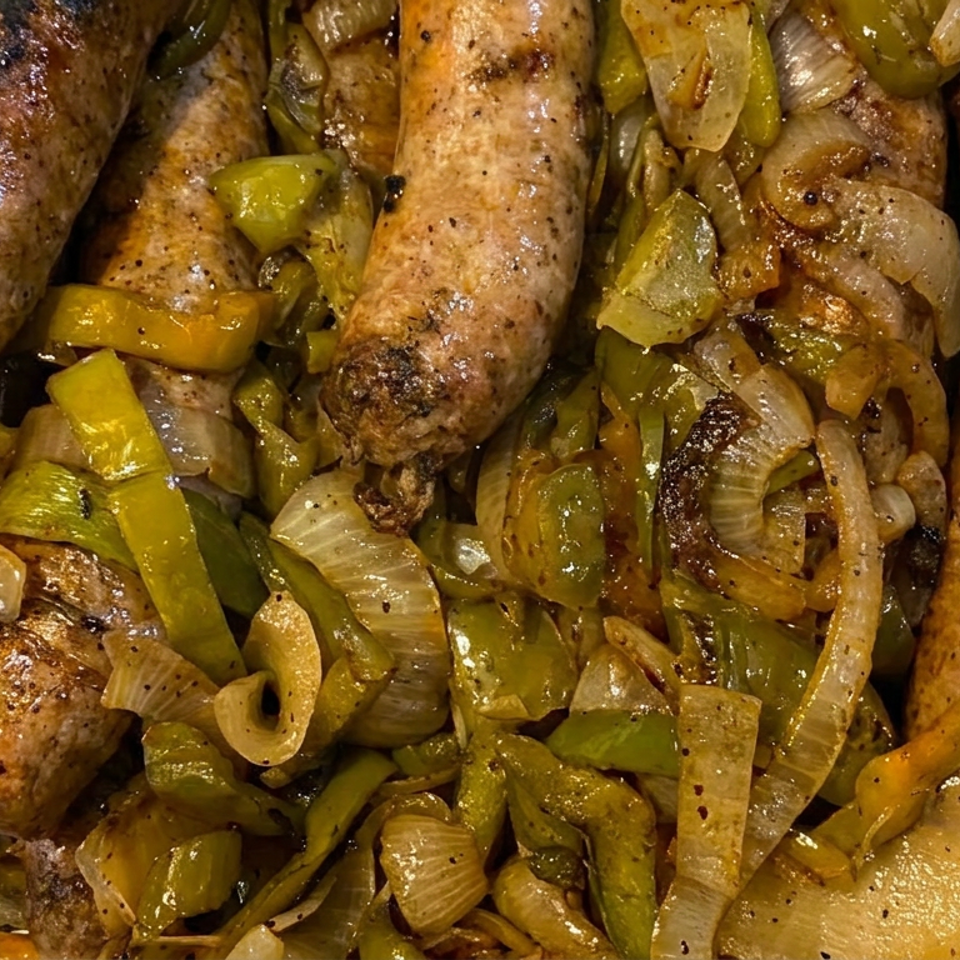Grilled sausages served with sautéed green peppers and onions in a foil tray.